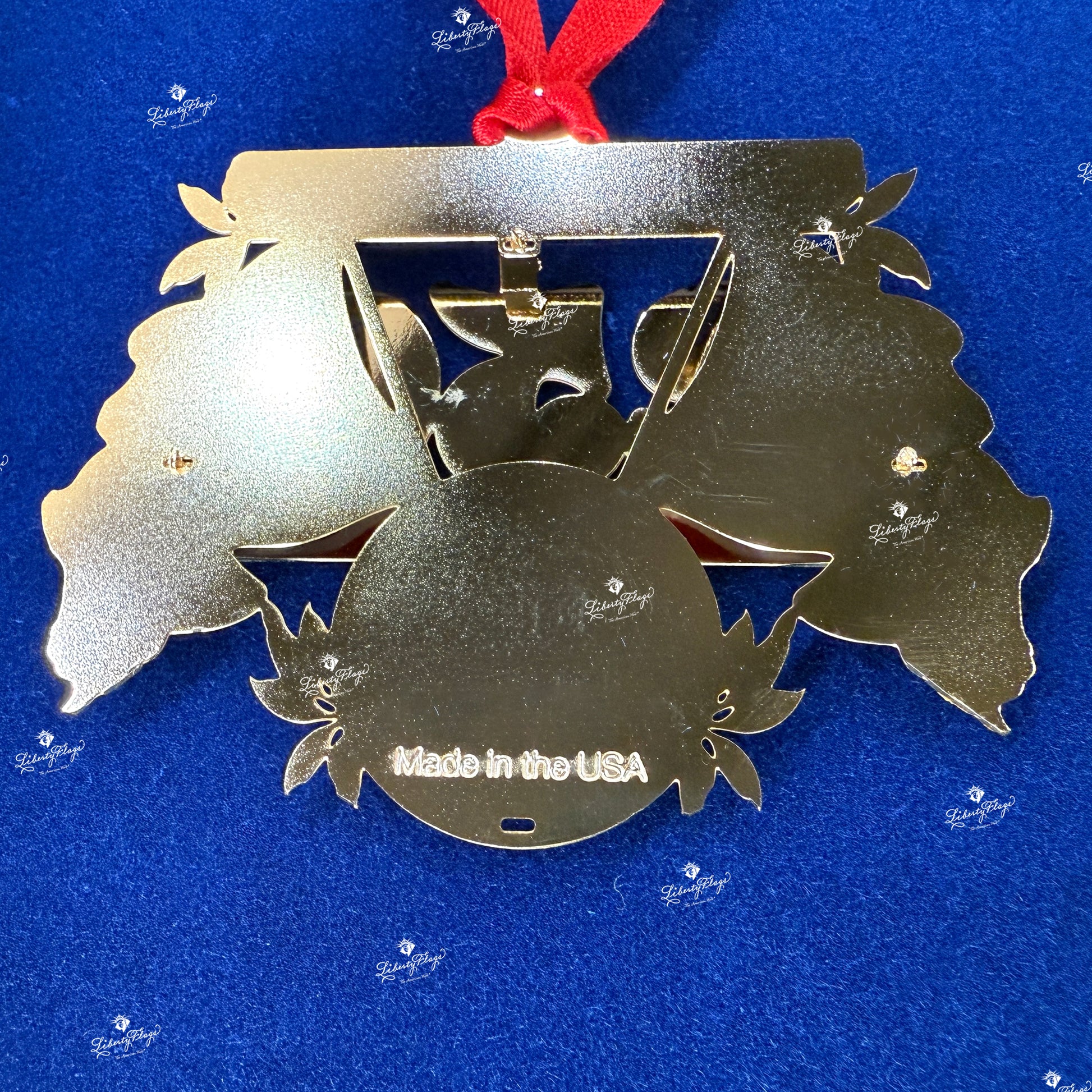 Back view of 250 Years of America keepsake ornament showing solid brass construction and gold finish, Made in the USA